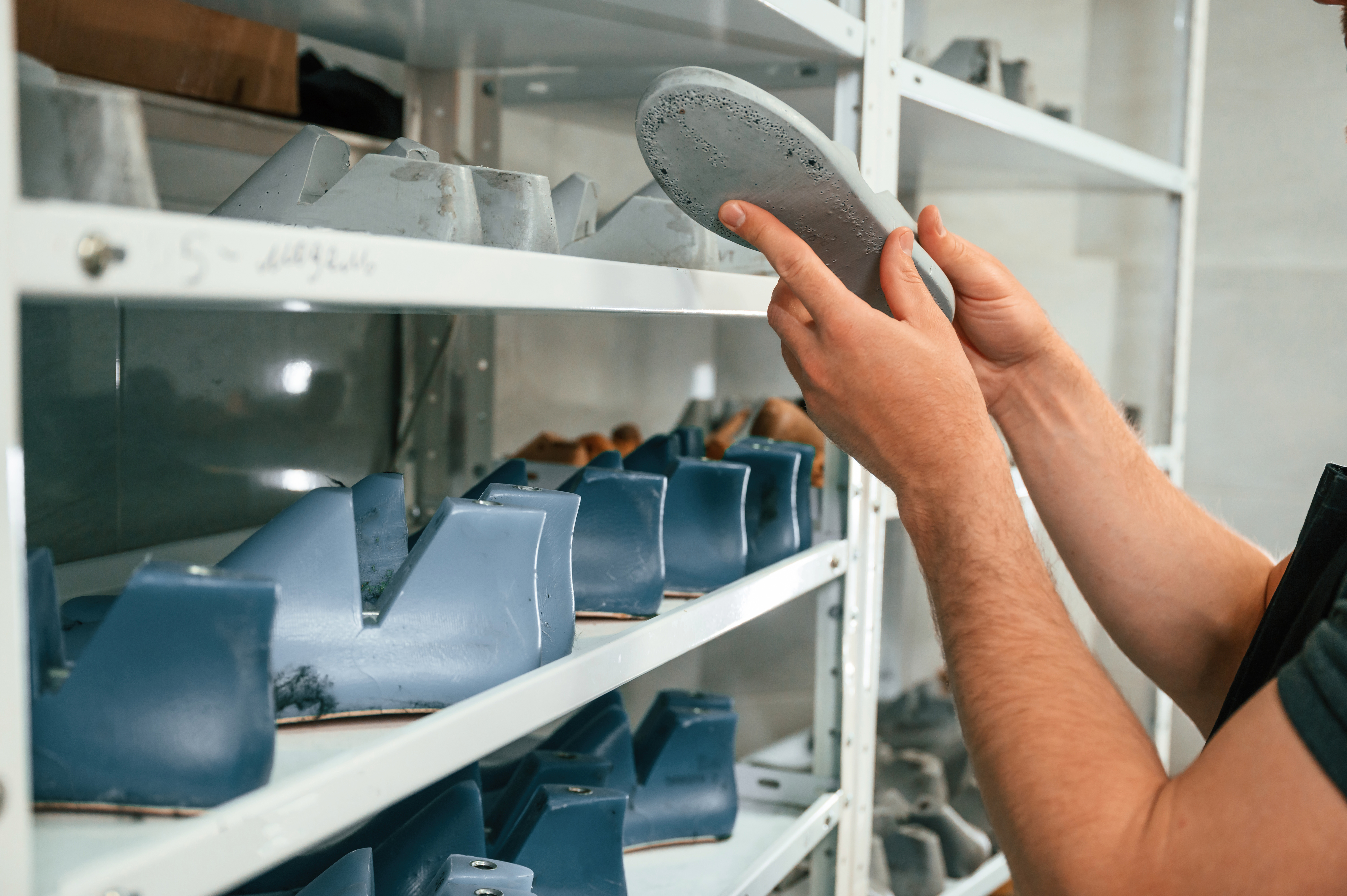 Footwear development professional inspecting product fit and quality during the sampling process
